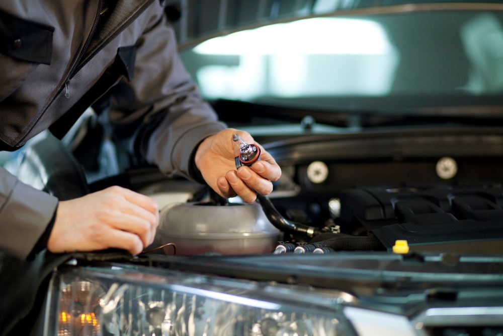 An Auto Electrician replacing a headlight