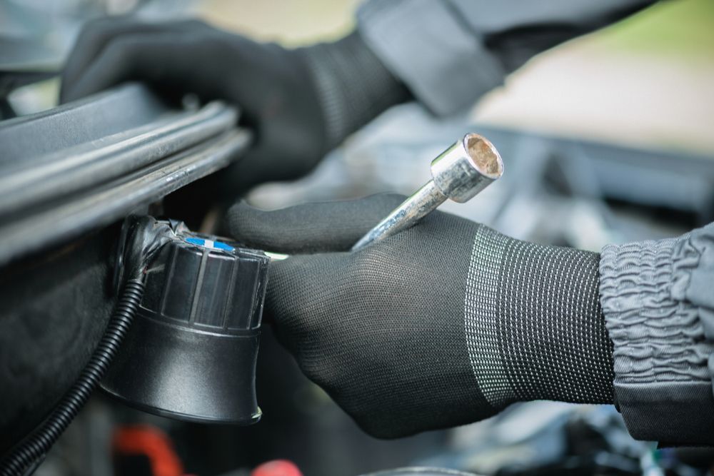 Auto electrician installing a car alarm